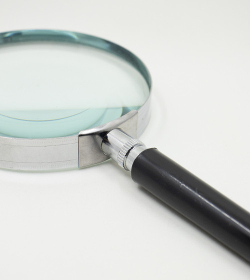 Round magnifying glass with black handle