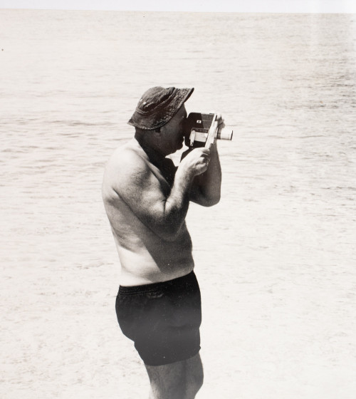 Black and white framed photo with person with camera